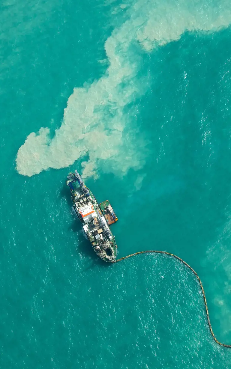 Ship dredging in turqouoise water